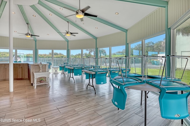 4000 Ocean Beach Blvd Unit 1J, Cocoa Beach, FL 32931 - sunroom / solarium with beamed ceiling, healthy amount of natural light, high vaulted ceiling, and wood finished floors