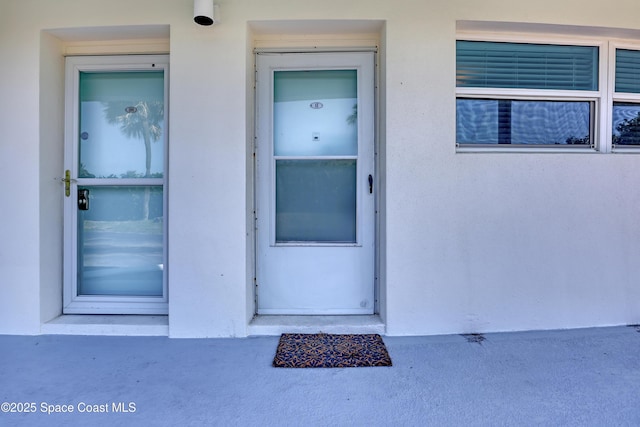 4000 Ocean Beach Blvd Unit 1J, Cocoa Beach, FL 32931 - view of exterior entry with stucco siding