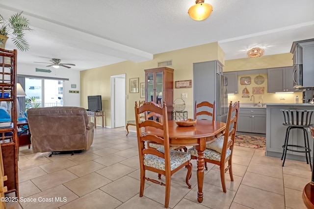 4000 Ocean Beach Blvd Unit 1J, Cocoa Beach, FL 32931 - dining room featuring ceiling fan and light tile patterned flooring