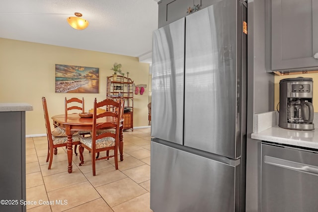 4000 Ocean Beach Blvd Unit 1J, Cocoa Beach, FL 32931 - dining room featuring light tile patterned floors and baseboards