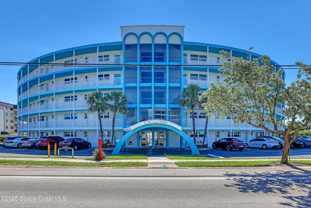 4000 Ocean Beach Blvd Unit 1J, Cocoa Beach, FL 32931 - view of apartment building / complex with uncovered parking