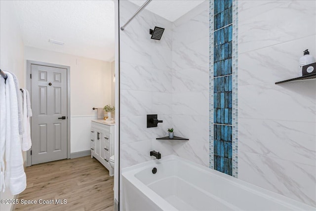 1020 Sycamore Dr, Rockledge, FL 32955 - bathroom featuring vanity, wood finished floors, and shower / bath combination