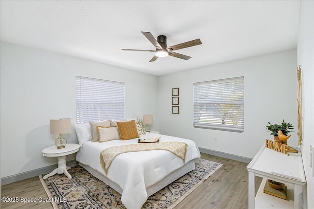 1020 Sycamore Dr, Rockledge, FL 32955 - bedroom with light wood-style flooring, baseboards, and a ceiling fan