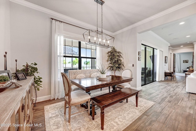 2291 Trava Ln, Melbourne, FL 32940 - dining space with light wood-style flooring, baseboards, a chandelier, ornamental molding, and recessed lighting