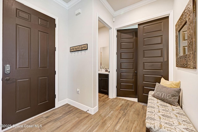 2291 Trava Ln, Melbourne, FL 32940 - entryway with light wood-style flooring, baseboards, and crown molding