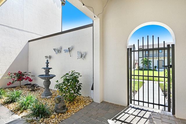 2291 Trava Ln, Melbourne, FL 32940 - doorway to property with a gate and stucco siding