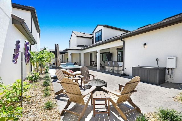2291 Trava Ln, Melbourne, FL 32940 - view of patio with a hot tub and a fire pit