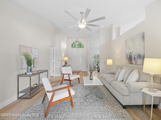 1750 Old Glory Blvd, Melbourne, FL 32940 - living area with a high ceiling, a ceiling fan, wood finished floors, and baseboards
