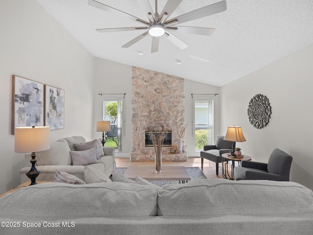 1750 Old Glory Blvd, Melbourne, FL 32940 - living room featuring wood finished floors, plenty of natural light, ceiling fan, a fireplace, and high vaulted ceiling