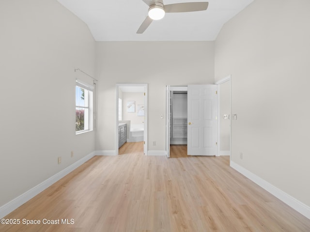 1750 Old Glory Blvd, Melbourne, FL 32940 - unfurnished bedroom with a spacious closet, light wood-style floors, ensuite bath, a closet, and baseboards