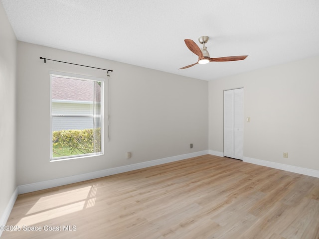 1750 Old Glory Blvd, Melbourne, FL 32940 - unfurnished room with light wood-style flooring, ceiling fan, and baseboards