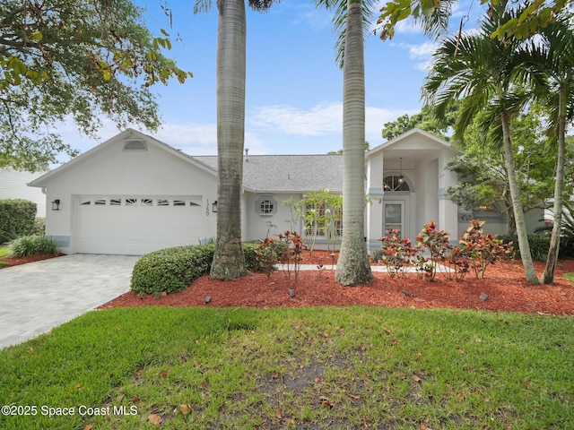 1750 Old Glory Blvd, Melbourne, FL 32940 - single story home featuring a garage, decorative driveway, and stucco siding