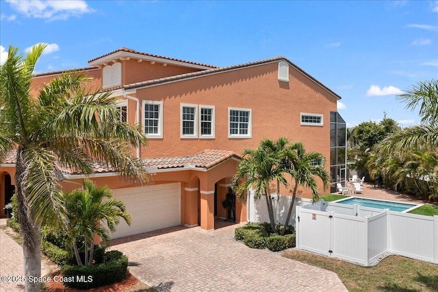 120 Mediterranean Way, Indian Harbour Beach, FL 32937 - mediterranean / spanish-style house with stucco siding, a tiled roof, decorative driveway, and a garage