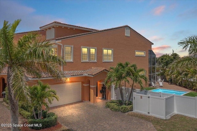 120 Mediterranean Way, Indian Harbour Beach, FL 32937 - mediterranean / spanish house with a tiled roof, stucco siding, a garage, and decorative driveway