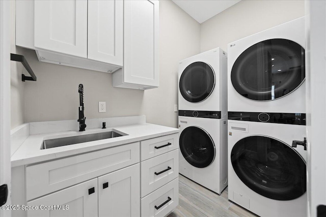 120 Mediterranean Way, Indian Harbour Beach, FL 32937 - laundry room featuring estacked washer and dryer, cabinet space, and light wood-style flooring