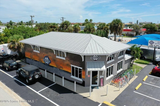 120 Mediterranean Way, Indian Harbour Beach, FL 32937 - view of building exterior featuring uncovered parking