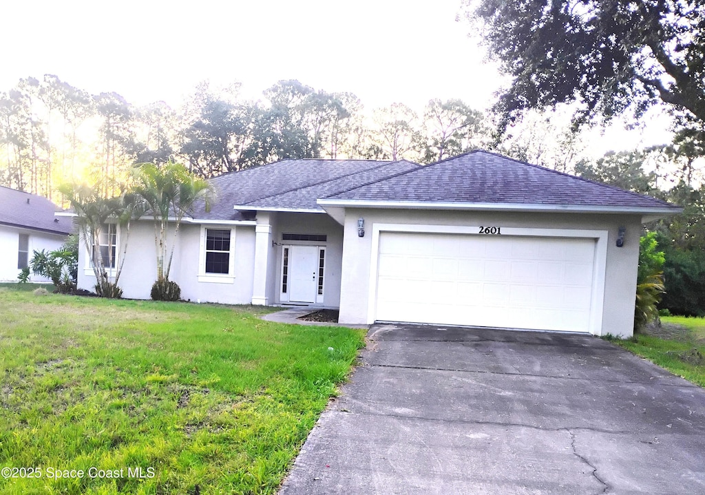 2601 Diane Ave SE, Palm Bay, FL 32909 - single story home featuring roof with shingles, stucco siding, a front yard, and driveway