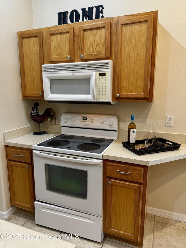 2601 Diane Ave SE, Palm Bay, FL 32909 - kitchen featuring white appliances, light countertops, and brown cabinets