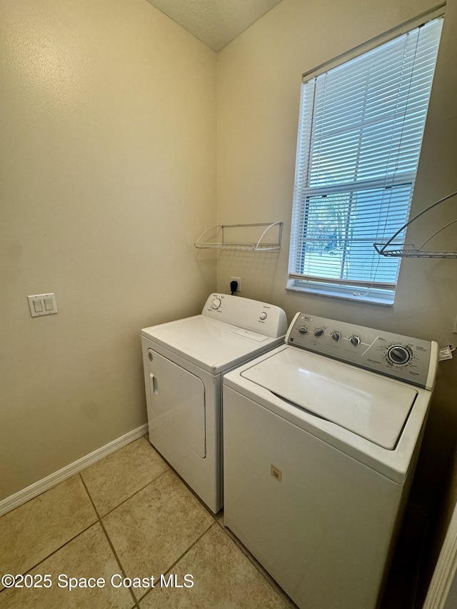 2601 Diane Ave SE, Palm Bay, FL 32909 - laundry area featuring washer and dryer, baseboards, and light tile patterned floors