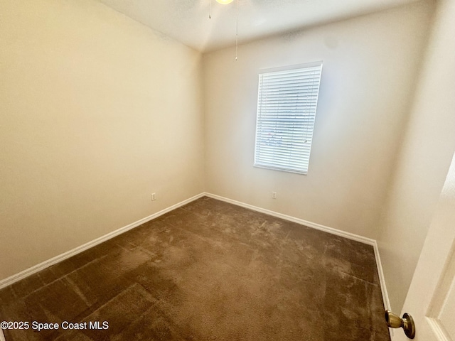 2601 Diane Ave SE, Palm Bay, FL 32909 - unfurnished room with dark colored carpet, baseboards, and ceiling fan