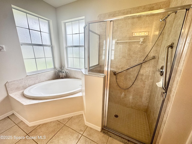 2601 Diane Ave SE, Palm Bay, FL 32909 - bathroom with a garden tub, a stall shower, tile patterned floors, and baseboards
