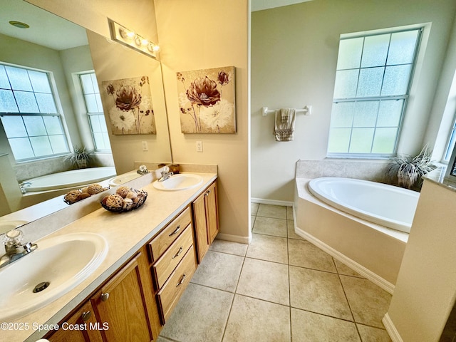 2601 Diane Ave SE, Palm Bay, FL 32909 - full bathroom featuring a garden tub, plenty of natural light, double vanity, and tile patterned flooring