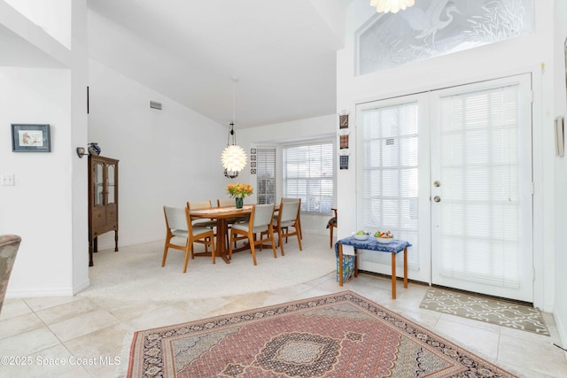 1181 Cypress Trace Dr, Melbourne, FL 32940 - dining room with light tile patterned floors, high vaulted ceiling, and baseboards