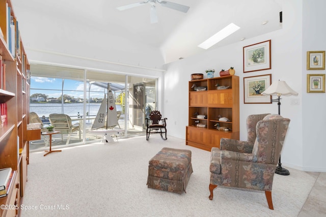 1181 Cypress Trace Dr, Melbourne, FL 32940 - sitting room featuring lofted ceiling, a ceiling fan, a water view, a skylight, and baseboards