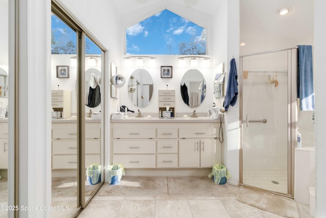 1181 Cypress Trace Dr, Melbourne, FL 32940 - bathroom with a stall shower, double vanity, high vaulted ceiling, and tile patterned floors