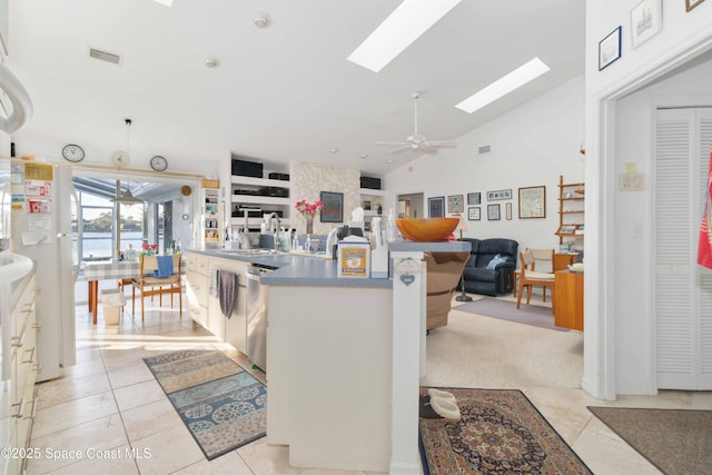 1181 Cypress Trace Dr, Melbourne, FL 32940 - kitchen featuring ceiling fan, freestanding refrigerator, a skylight, light tile patterned floors, and open floor plan