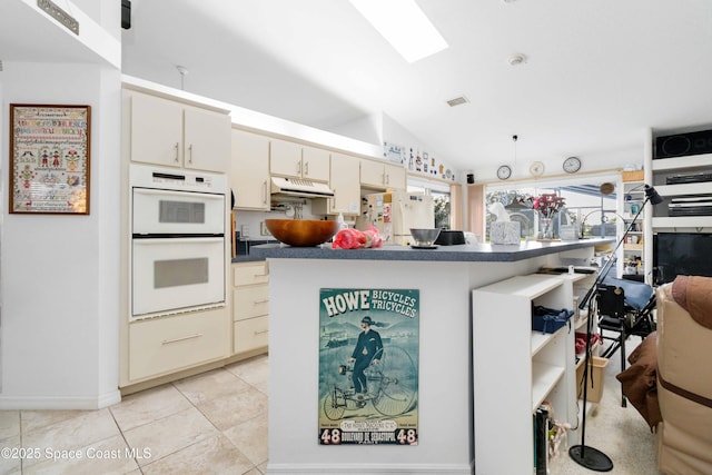 1181 Cypress Trace Dr, Melbourne, FL 32940 - kitchen with white appliances, dark countertops, lofted ceiling, under cabinet range hood, and light tile patterned floors
