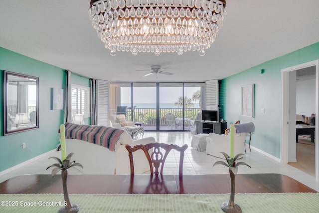 1527 S Atlantic Ave Unit 201, Cocoa Beach, FL 32931 - tiled living room featuring baseboards, a wall of windows, and ceiling fan