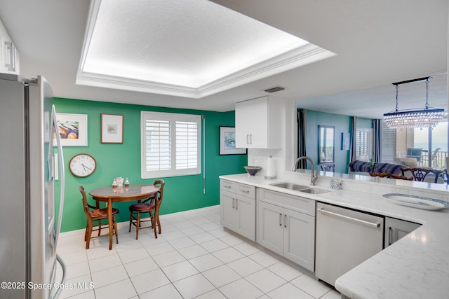 1527 S Atlantic Ave Unit 201, Cocoa Beach, FL 32931 - kitchen featuring appliances with stainless steel finishes, a sink, baseboards, and a raised ceiling