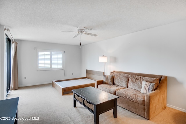 1527 S Atlantic Ave Unit 201, Cocoa Beach, FL 32931 - living room with a ceiling fan, light colored carpet, baseboards, and a textured ceiling