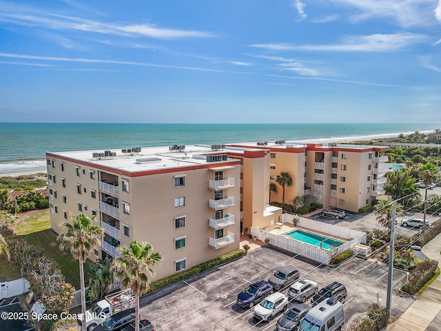 1527 S Atlantic Ave Unit 201, Cocoa Beach, FL 32931 - view of apartment building / complex featuring uncovered parking and a water view