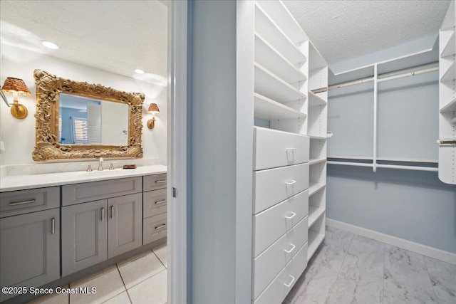 1527 S Atlantic Ave Unit 201, Cocoa Beach, FL 32931 - spacious closet featuring a sink and light marble finish flooring