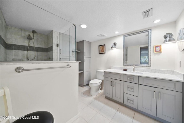 1527 S Atlantic Ave Unit 201, Cocoa Beach, FL 32931 - full bathroom with vanity, a walk in shower, tile patterned flooring, a textured ceiling, and recessed lighting
