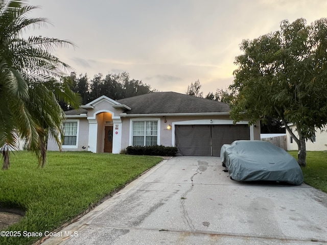 2642 Fleming Ave SW, Palm Bay, FL 32908 - ranch-style home with a garage, driveway, a front lawn, and stucco siding