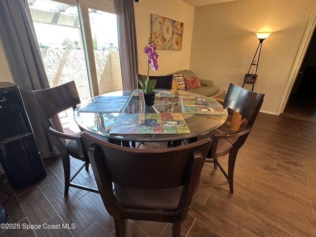 1021 Abada Ct NE Unit 106, Palm Bay, FL 32905 - dining room featuring plenty of natural light and dark wood-style floors