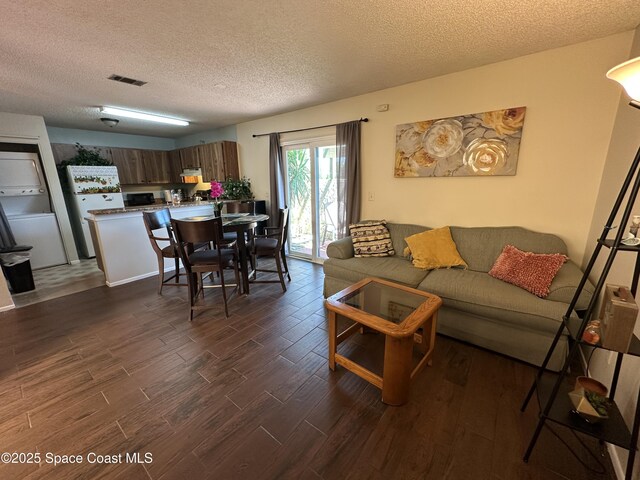 1021 Abada Ct NE Unit 106, Palm Bay, FL 32905 - living area with dark wood-style floors and a textured ceiling