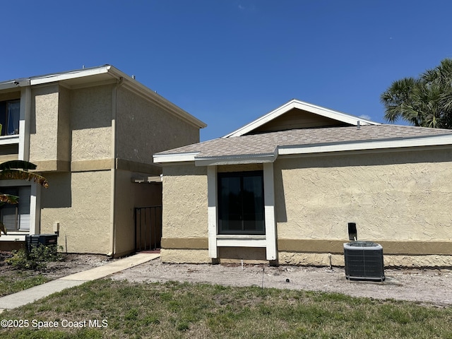 1021 Abada Ct NE Unit 106, Palm Bay, FL 32905 - back of property with central AC and stucco siding