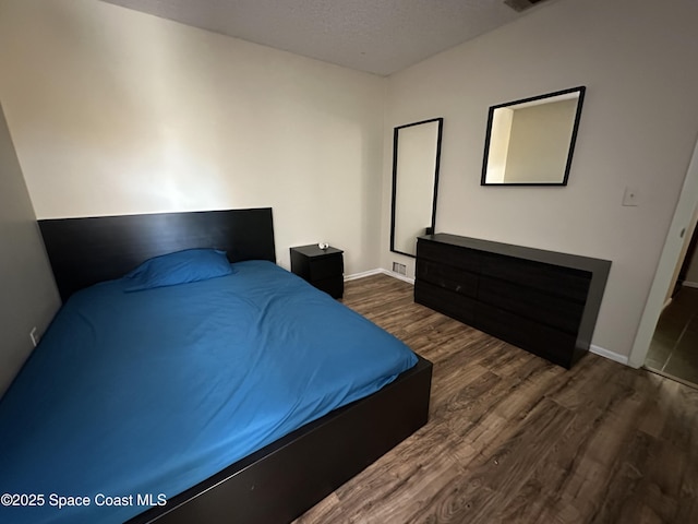 1021 Abada Ct NE Unit 106, Palm Bay, FL 32905 - bedroom featuring wood finished floors and baseboards