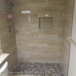 635 Seaport Blvd Unit T257, Cape Canaveral, FL 32920 - bathroom featuring a tile shower and toilet
