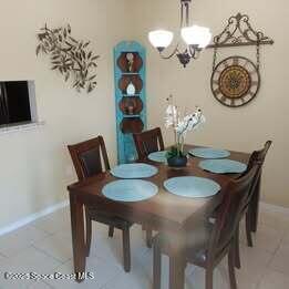 635 Seaport Blvd Unit T257, Cape Canaveral, FL 32920 - dining space with a chandelier, baseboards, and tile patterned flooring