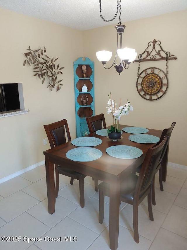 635 Seaport Blvd Unit T257, Cape Canaveral, FL 32920 - dining room featuring light tile patterned floors, baseboards, and a chandelier