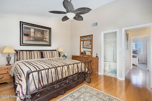 635 Seaport Blvd Unit T257, Cape Canaveral, FL 32920 - bedroom featuring attic access, wood finished floors, lofted ceiling, baseboards, and ensuite bathroom
