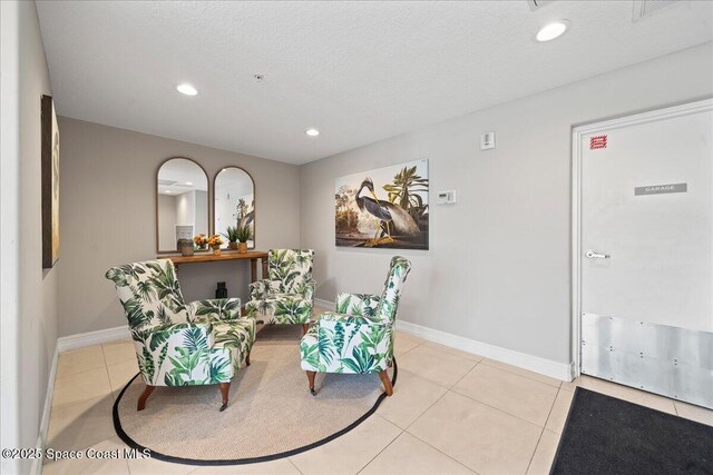 1825 Riverside Dr Unit 205, Titusville, FL 32780 - sitting room featuring tile patterned flooring, recessed lighting, baseboards, and a textured ceiling