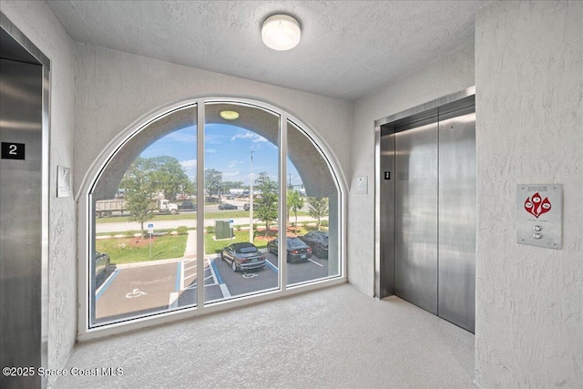 1825 Riverside Dr Unit 205, Titusville, FL 32780 - empty room with a textured wall, a textured ceiling, and elevator