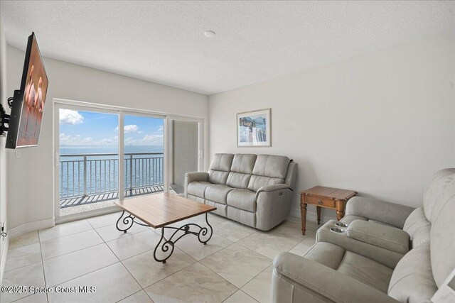 1825 Riverside Dr Unit 205, Titusville, FL 32780 - living room with baseboards, a textured ceiling, and light tile patterned floors