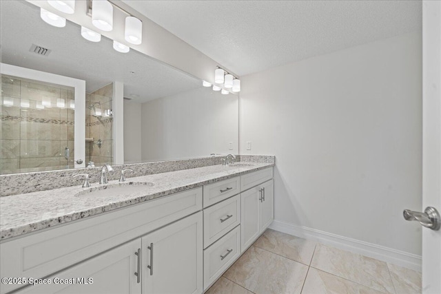 1825 Riverside Dr Unit 205, Titusville, FL 32780 - full bath featuring double vanity, a shower stall, baseboards, a textured ceiling, and marble finish flooring